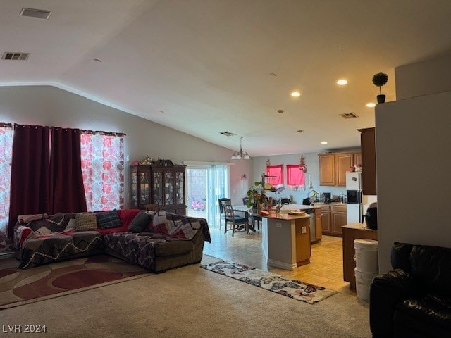 carpeted living room featuring a chandelier and lofted ceiling