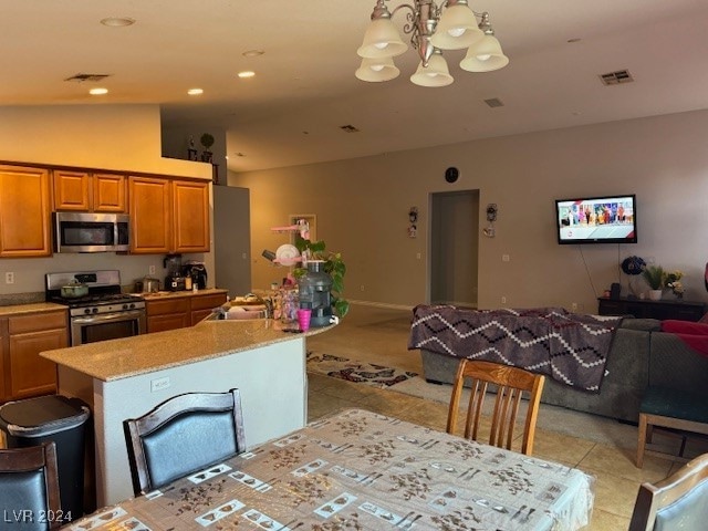 tiled dining area featuring sink, lofted ceiling, and a notable chandelier