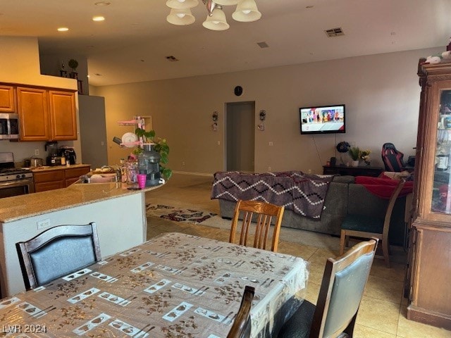 dining area with sink and an inviting chandelier