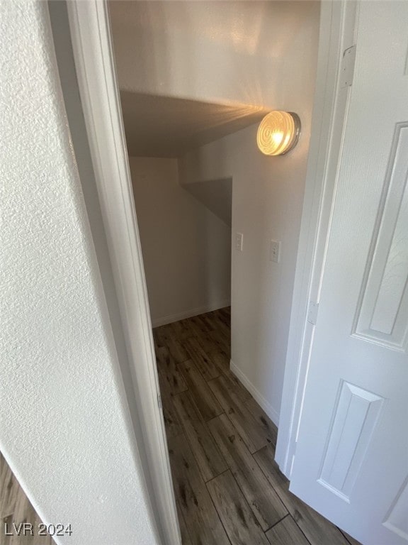 corridor with dark hardwood / wood-style floors