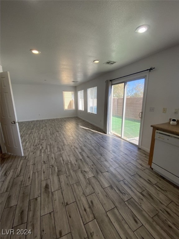 unfurnished living room featuring a textured ceiling and light wood-type flooring