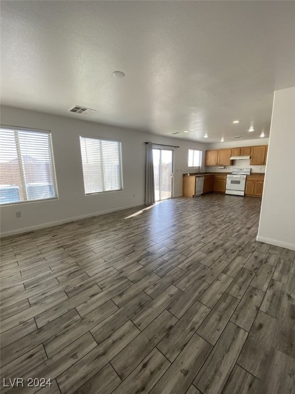 unfurnished living room featuring a textured ceiling and hardwood / wood-style flooring