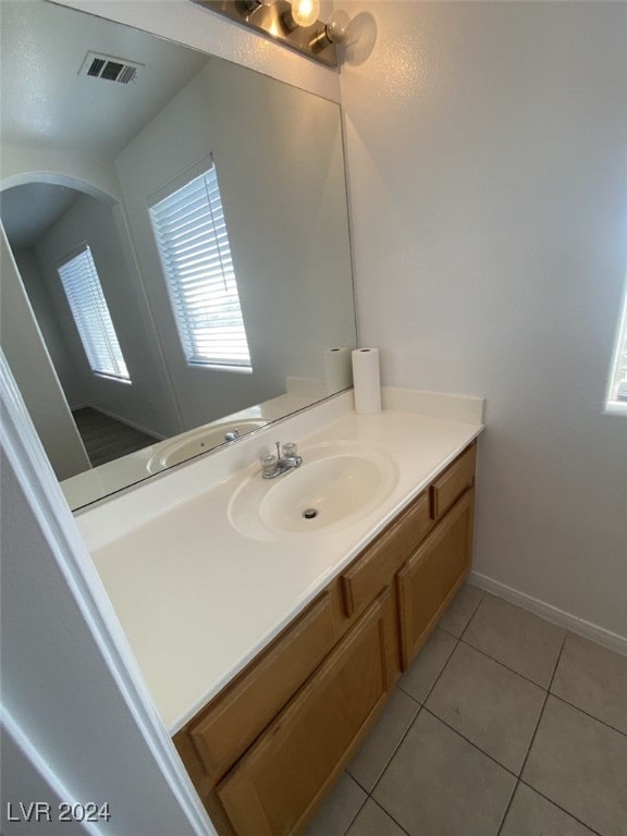 bathroom with tile patterned floors and vanity