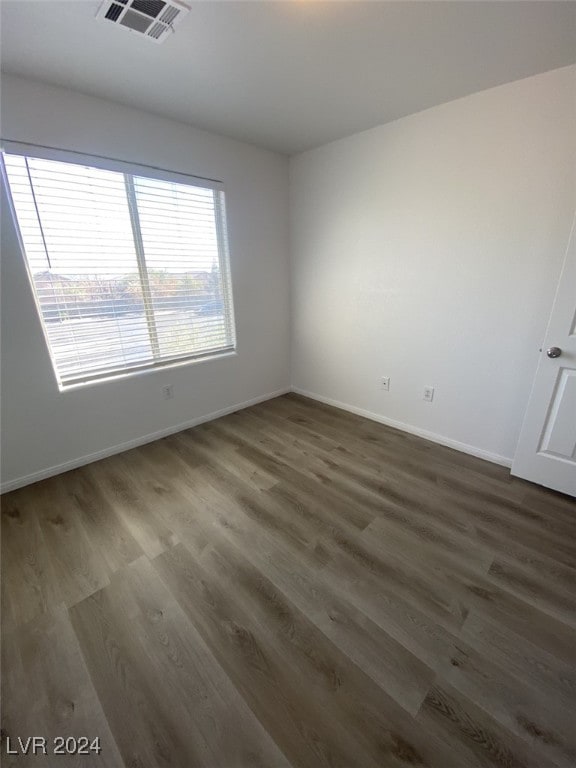 spare room featuring dark hardwood / wood-style flooring