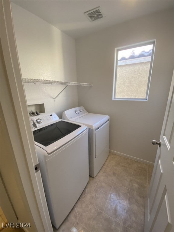 washroom with washing machine and clothes dryer