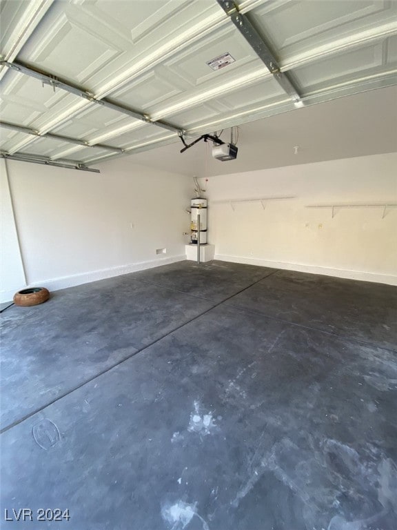 garage with strapped water heater and a garage door opener