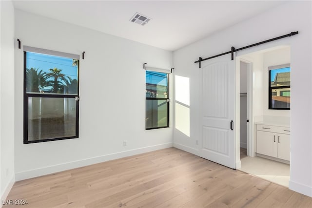 spare room featuring light hardwood / wood-style flooring and plenty of natural light