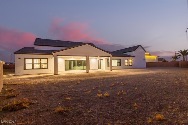 view of back house at dusk