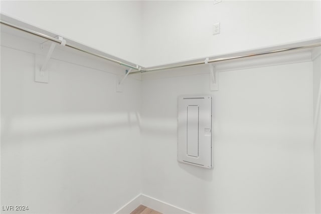 walk in closet with wood-type flooring and electric panel