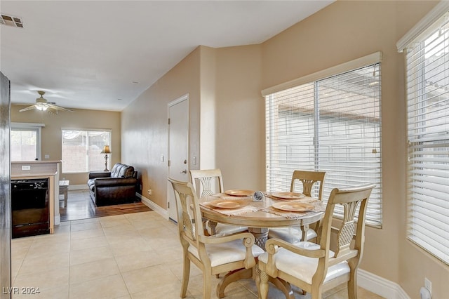 dining room featuring light tile patterned flooring, baseboards, visible vents, and ceiling fan