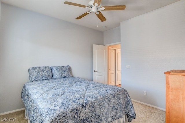 bedroom with baseboards, light colored carpet, and a ceiling fan