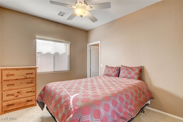 bedroom featuring light carpet, visible vents, a ceiling fan, and baseboards