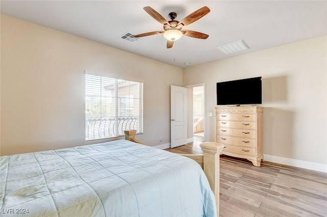 bedroom with visible vents, light wood-style flooring, and baseboards