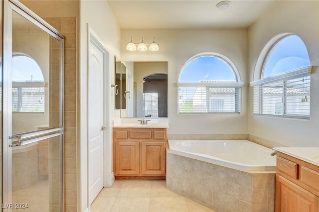 full bathroom with tile patterned flooring, a shower stall, a garden tub, and vanity