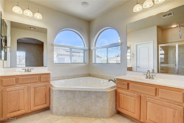 bathroom with a garden tub, visible vents, a shower stall, and a sink