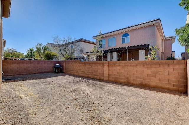 exterior space featuring a fenced backyard and stucco siding