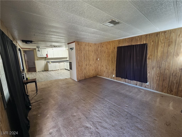 interior space featuring wood walls and a textured ceiling