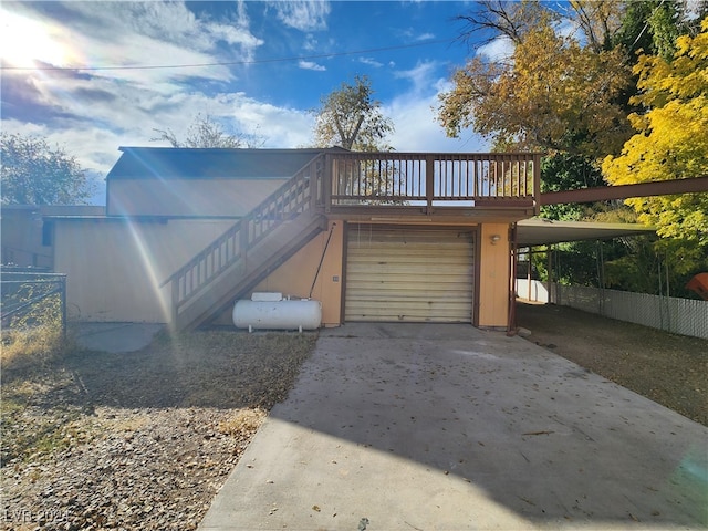 view of front of home with a deck and a carport