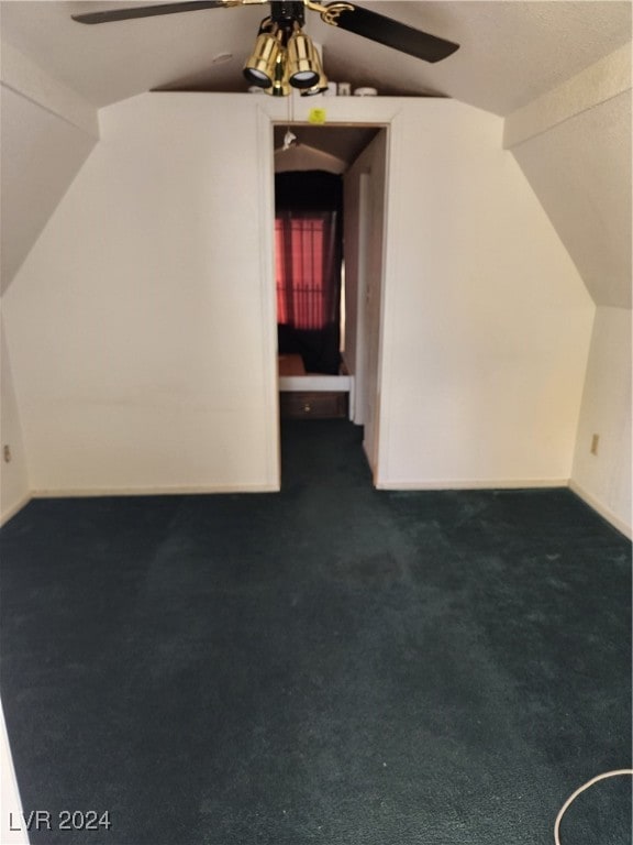 bonus room with dark colored carpet, ceiling fan, and lofted ceiling