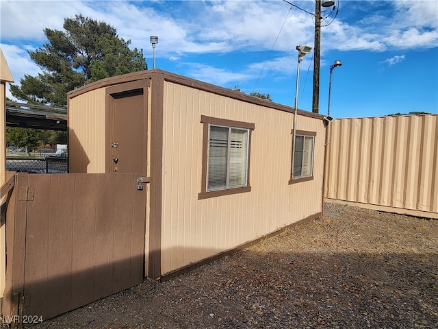 view of home's exterior with a storage unit