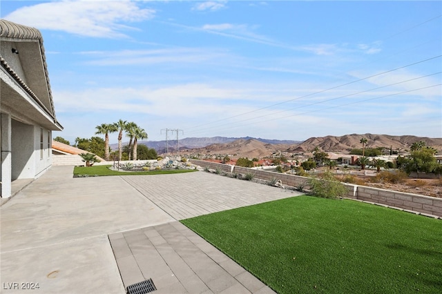 view of yard with a mountain view and a patio