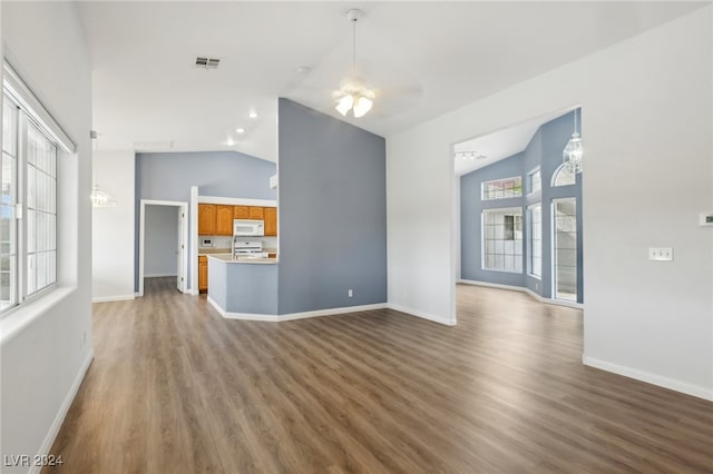 unfurnished living room with hardwood / wood-style flooring, ceiling fan, and vaulted ceiling