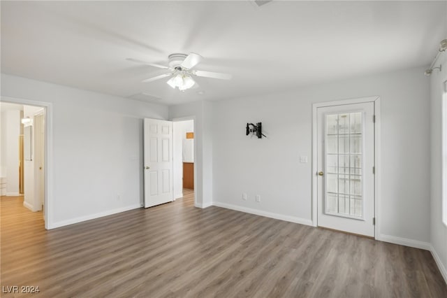 empty room with ceiling fan and hardwood / wood-style flooring