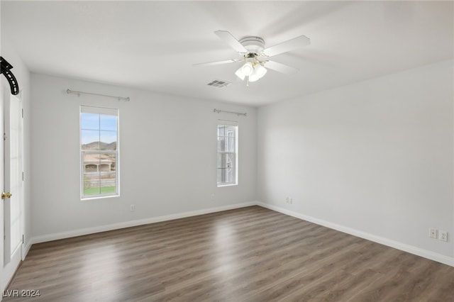 unfurnished room featuring ceiling fan and dark hardwood / wood-style flooring