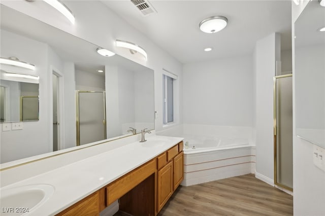 bathroom with separate shower and tub, vanity, and wood-type flooring