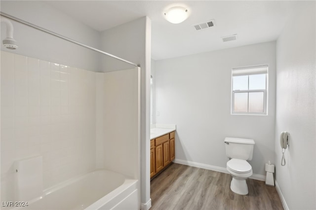 full bathroom featuring shower / washtub combination, toilet, vanity, and hardwood / wood-style flooring