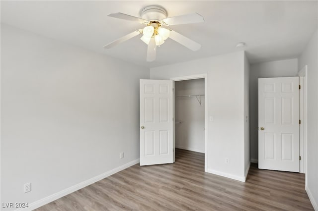 unfurnished bedroom featuring wood-type flooring, a closet, and ceiling fan