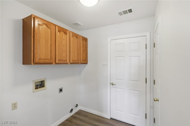 clothes washing area with electric dryer hookup, dark hardwood / wood-style floors, cabinets, and hookup for a washing machine