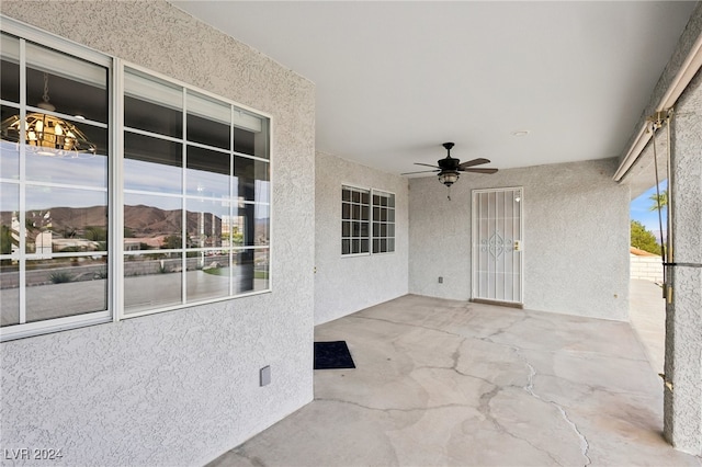 view of patio with a mountain view and ceiling fan