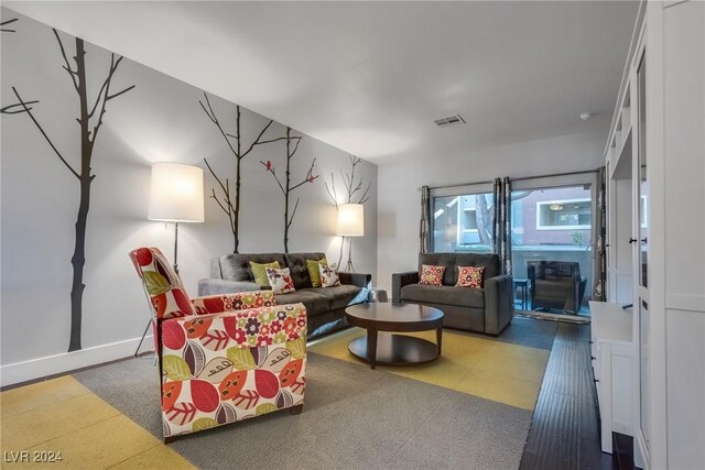 living area with baseboards and visible vents