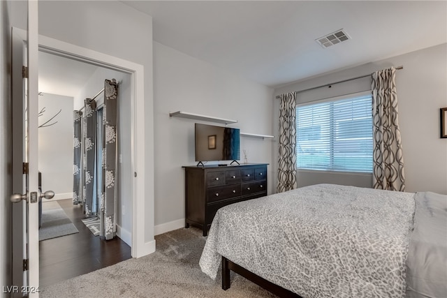 bedroom featuring baseboards, visible vents, and dark carpet