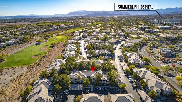 bird's eye view with a residential view, view of golf course, and a mountain view