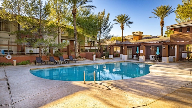 pool featuring a patio area and fence