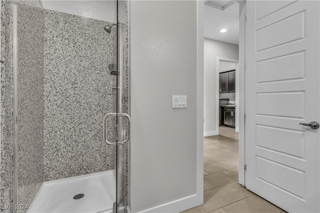 bathroom with tile patterned flooring and walk in shower