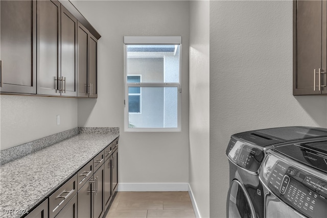 washroom with cabinets and washer and clothes dryer