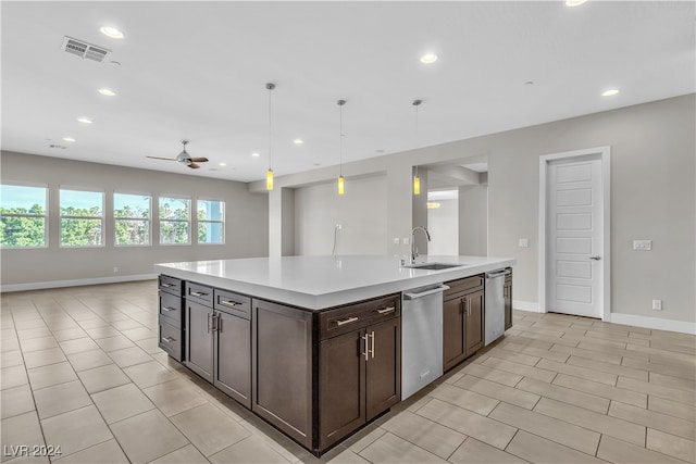 kitchen with ceiling fan, dishwasher, sink, hanging light fixtures, and a kitchen island with sink