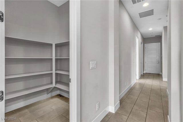 corridor featuring light tile patterned floors