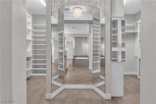 walk in closet featuring tile patterned flooring