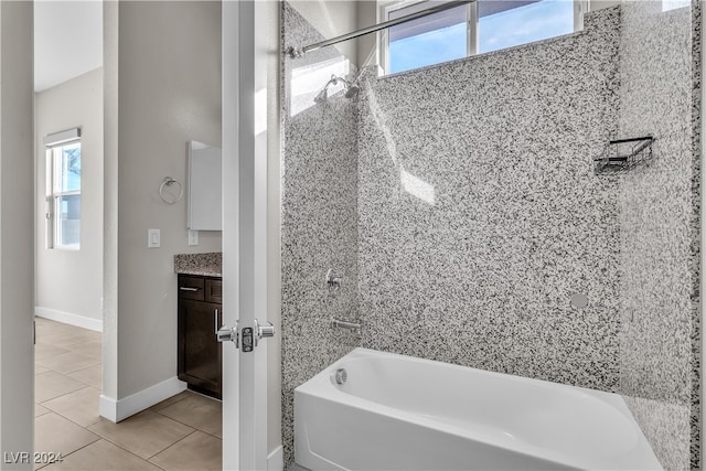 bathroom featuring tile patterned flooring, vanity, and tiled shower / bath