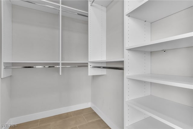 spacious closet featuring light tile patterned floors