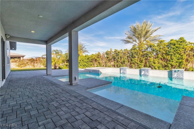 view of pool with a patio and pool water feature