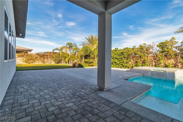 view of swimming pool with a patio area and an in ground hot tub