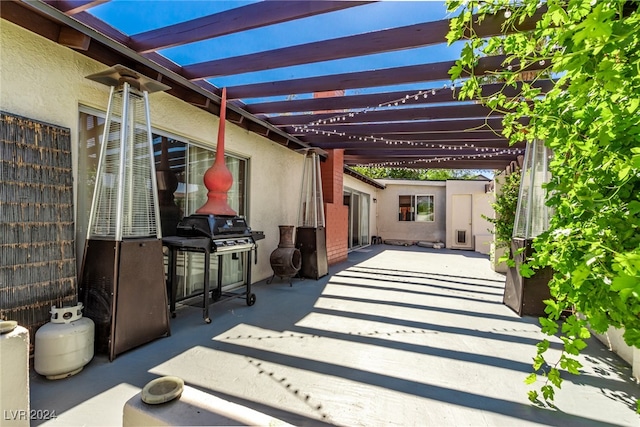 view of patio / terrace with a pergola and grilling area