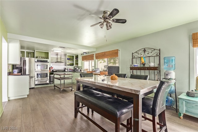 dining area featuring light hardwood / wood-style floors and ceiling fan