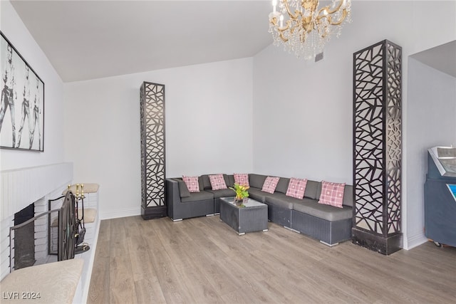 living room with hardwood / wood-style floors and a notable chandelier