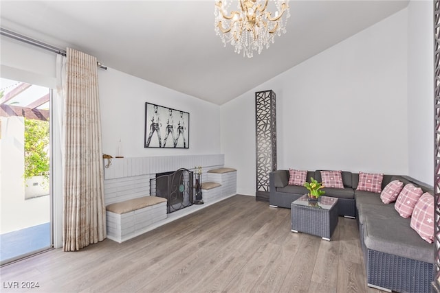 living room with an inviting chandelier and hardwood / wood-style flooring